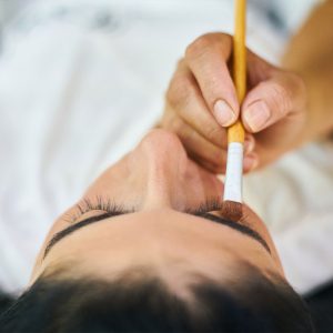 A top-down view of a woman's head, as an eyebrow treatment is applied as part of an eyebrow course in Manchester.